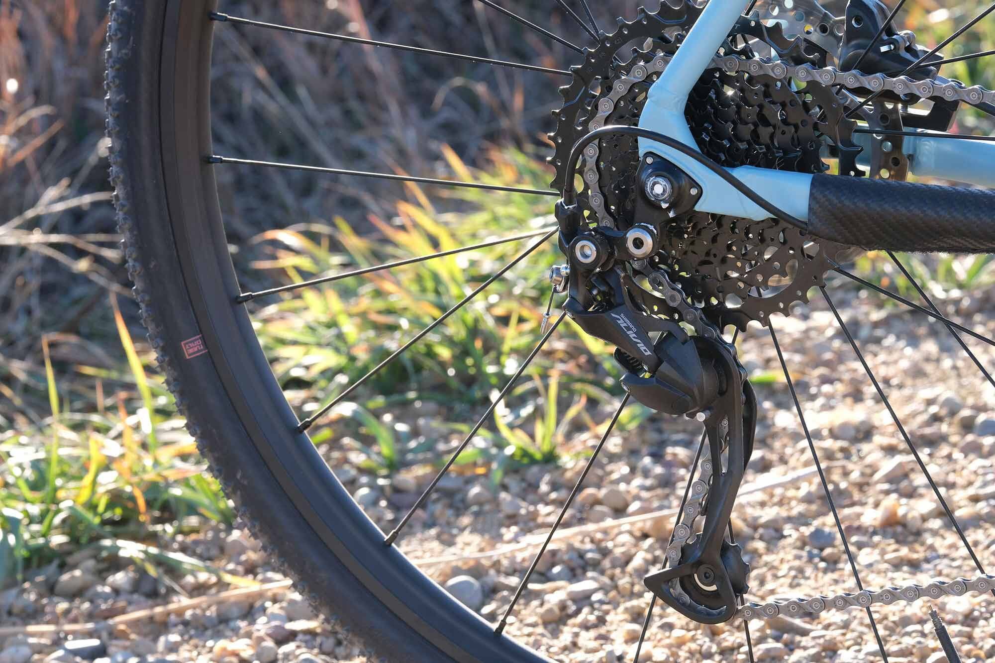 A Shimano Alivio nine-speed derailleur shifts across a wide-range 11-42T Microshift cassette.